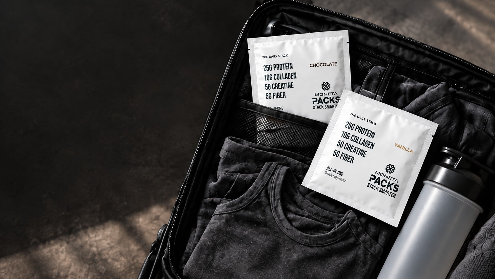 Moneta PACKS tucked into black carry-on luggage